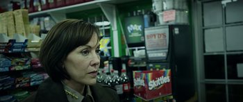 Movie still from “Broken” (2021), directed by Patrick Phillips – A woman in uniform is sitting in front of a soda machine; Close Up shot, Over the shoulder angle