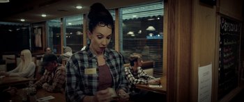 Movie still from “Broken” (2021), directed by Patrick Phillips – A woman sitting at a table in front of a man; Medium shot, Over the shoulder angle