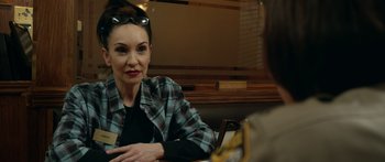 Movie still from “Broken” (2021), directed by Patrick Phillips – A woman sitting in front of a man in front of a table; Close Up shot, Over the shoulder angle