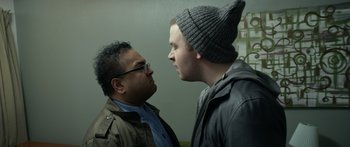 Movie still from “Broken” (2021), directed by Patrick Phillips – Two men standing next to each other in a room; Close Up shot, Over the shoulder angle