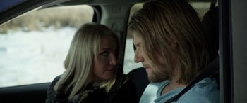 Movie still from “Broken” (2021), directed by Patrick Phillips – A man and a woman sitting in the back of a car; Close Up shot, Over the shoulder angle