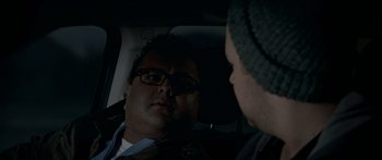 Movie still from “Broken” (2021), directed by Patrick Phillips – Two men in the back seat of a car talking; Close Up shot, Over the shoulder angle