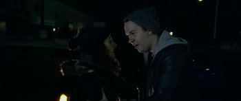 Movie still from “Broken” (2021), directed by Patrick Phillips – A man and a woman standing next to each other in the dark; Close Up shot, Over the shoulder angle