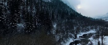 Movie still from “Broken” (2021), directed by Patrick Phillips – A view of a snowy mountain with trees in the background; Extreme Wide shot, High angle