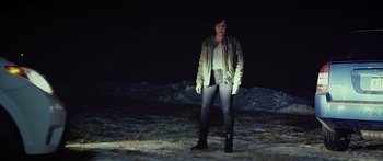 Movie still from “Broken” (2021), directed by Patrick Phillips – A woman standing in the snow at night; Medium shot, High angle