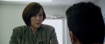 Movie still from “Broken” (2021), directed by Patrick Phillips – A woman is looking at a man in the mirror; Close Up shot, Over the shoulder angle