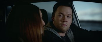 Movie still from “Broken” (2021), directed by Patrick Phillips – A man and a woman sitting in a car looking at each other; Close Up shot, Over the shoulder angle