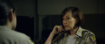 Movie still from “Broken” (2021), directed by Patrick Phillips – A person sitting in front of a mirror; Close Up shot, Over the shoulder angle