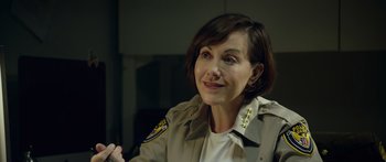 Movie still from “Broken” (2021), directed by Patrick Phillips – A person wearing a jacket; Close Up shot, Over the shoulder angle