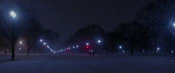 Movie still from “Broken” (2021), directed by Patrick Phillips – Two people are standing in the snow at night; Extreme Wide shot, High angle
