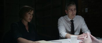 Movie still from “Broken” (2021), directed by Patrick Phillips – A man and a woman sitting at a table; Medium shot, Over the shoulder angle