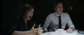 Movie still from “Broken” (2021), directed by Patrick Phillips – A woman and a man sitting at a table; Medium shot, Over the shoulder angle