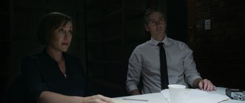 Movie still from “Broken” (2021), directed by Patrick Phillips – Two men sitting at a table in front of each other; Medium shot, Over the shoulder angle