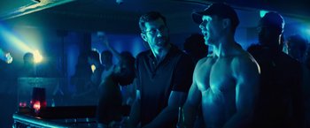 Movie still from “Bros” (2022), directed by Nicholas Stoller – Two men standing next to each other in a room; Medium shot, Over the shoulder angle