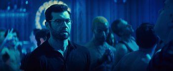 Movie still from “Bros” (2022), directed by Nicholas Stoller – A group of people standing in a room; Close Up shot, Over the shoulder angle