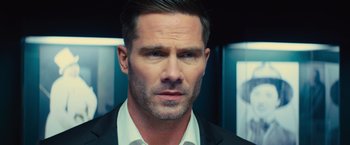 Movie still from “Bros” (2022), directed by Nicholas Stoller – A person wearing a suit and tie; Close Up shot, Over the shoulder angle