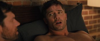 Movie still from “Bros” (2022), directed by Nicholas Stoller – A man laying in bed with his mouth open; Close Up shot, High angle
