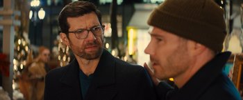Movie still from “Bros” (2022), directed by Nicholas Stoller – A man with a beard and glasses talking to another man; Close Up shot, Over the shoulder angle