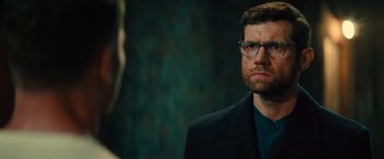 Movie still from “Bros” (2022), directed by Nicholas Stoller – A man with glasses is looking at the camera; Close Up shot, Over the shoulder angle