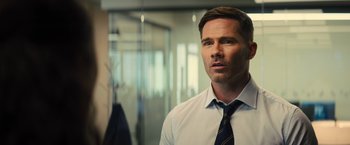 Movie still from “Bros” (2022), directed by Nicholas Stoller – A person wearing a shirt and a tie; Close Up shot, Over the shoulder angle