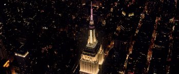 Movie still from “Bros” (2022), directed by Nicholas Stoller – An aerial view of the empire state building lit up at night; Extreme Wide shot, High angle