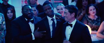 Movie still from “Bros” (2022), directed by Nicholas Stoller – A group of men in suits and ties standing next to each other; Medium shot, Over the shoulder angle