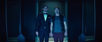 Movie still from “Bros” (2022), directed by Nicholas Stoller – A couple of men standing next to each other; Medium shot, Low angle