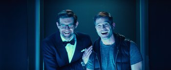 Movie still from “Bros” (2022), directed by Nicholas Stoller – A couple of men standing next to each other; Medium shot, Low angle