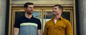 Movie still from “Bros” (2022), directed by Nicholas Stoller – A couple of men standing next to each other; Medium shot, Over the shoulder angle