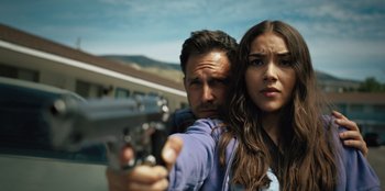 A man and a woman holding a gun