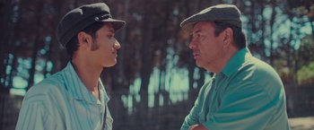 Movie still from “Burning Patience” (2022), directed by Rodrigo Sepúlveda – A man and a woman talking to each other outside; Close Up shot, Over the shoulder angle