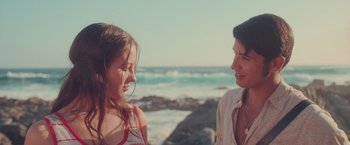 Movie still from “Burning Patience” (2022), directed by Rodrigo Sepúlveda – Two women talking on the beach near the ocean; Medium shot, Over the shoulder angle