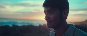 Movie still from “Burning Patience” (2022), directed by Rodrigo Sepúlveda – A person looking out a window; Close Up shot, Over the shoulder angle