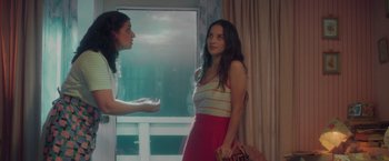 Movie still from “Burning Patience” (2022), directed by Rodrigo Sepúlveda – Two young women standing in front of a window; Medium shot, Over the shoulder angle