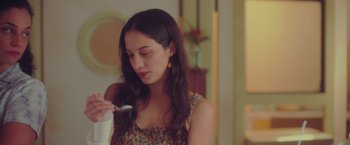 Movie still from “Burning Patience” (2022), directed by Rodrigo Sepúlveda – A young woman holding a toothbrush in her mouth; Close Up shot, Over the shoulder angle