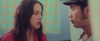 Movie still from “Burning Patience” (2022), directed by Rodrigo Sepúlveda – A woman and a man are talking to each other; Close Up shot, Over the shoulder angle