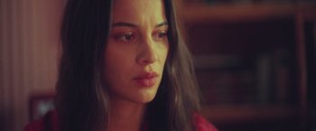 Movie still from “Burning Patience” (2022), directed by Rodrigo Sepúlveda – A person with long black hair; Close Up shot, Low angle