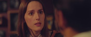 Movie still from “Burning Patience” (2022), directed by Rodrigo Sepúlveda – A person looking at a camera; Close Up shot, Over the shoulder angle