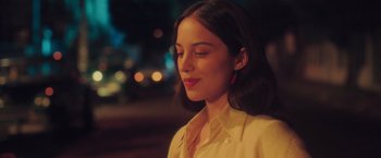 Movie still from “Burning Patience” (2022), directed by Rodrigo Sepúlveda – A beautiful young lady with long dark brown hair; Close Up shot, Over the shoulder angle