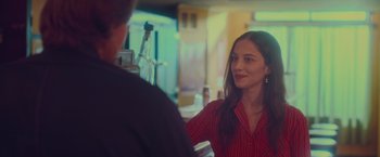 Movie still from “Burning Patience” (2022), directed by Rodrigo Sepúlveda – A woman in a red shirt talking to a man in a black shirt; Close Up shot, Over the shoulder angle