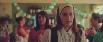 Movie still from “Burning Patience” (2022), directed by Rodrigo Sepúlveda – A woman in a nun's outfit standing next to another woman in a bar; Close Up shot, Over the shoulder angle