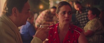 Movie still from “Burning Patience” (2022), directed by Rodrigo Sepúlveda – A person sitting in front of another person; Close Up shot, Over the shoulder angle