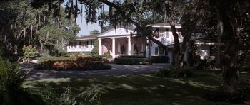 Movie still from “Cape Fear” (1991), directed by Martin Scorsese – A large white house with a clock on it's side; Extreme Wide shot, Low angle
