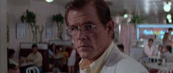 Movie still from “Cape Fear” (1991), directed by Martin Scorsese – A person wearing glasses; Close Up shot, Over the shoulder angle