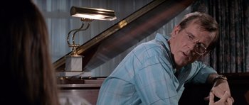 Movie still from “Cape Fear” (1991), directed by Martin Scorsese – A man sitting at a piano with his head resting on his arm; Close Up shot, Low angle