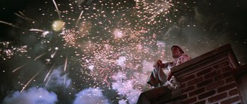 Movie still from “Cape Fear” (1991), directed by Martin Scorsese – A man sitting in front of a fireworks display; Wide shot, Low angle