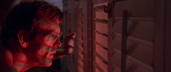 Movie still from “Cape Fear” (1991), directed by Martin Scorsese – A man looking out of a window at night; Close Up shot, Low angle