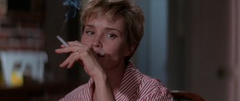 Movie still from “Cape Fear” (1991), directed by Martin Scorsese – A woman is smoking a cigarette in a room; Close Up shot, Low angle