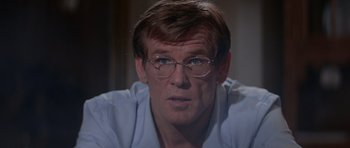 Movie still from “Cape Fear” (1991), directed by Martin Scorsese – A person wearing glasses and a white shirt; Close Up shot, Over the shoulder angle