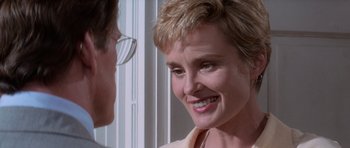 Movie still from “Cape Fear” (1991), directed by Martin Scorsese – A woman with short blonde hair smiles at a man with glasses; Close Up shot, Over the shoulder angle